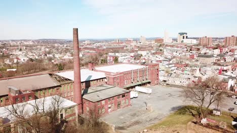 Aerial-over-an-abandoned-American-factory-with-smokestack-near-Reading-Pennsylvania-1