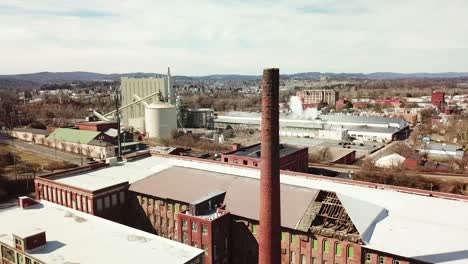Aerial-over-an-abandoned-American-factory-with-smokestack-near-Reading-Pennsylvania-3