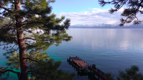 Pretty-establishing-shot-of-the-shores-of-Lake-Tahoe-Nevada-with-Sierras-and-pier