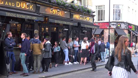 Locals-have-a-drink-at-a-pub-after-work-in-downtown-London-England