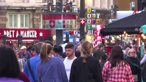 Large-crowds-of-people-move-through-Leicester-Square-London-England-at-rush-hour