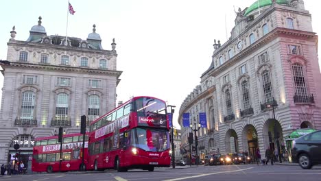 Early-evening-doubledecker-bus-and-London-taxi-traffic-moves-through-Piccadilly-Circus-1