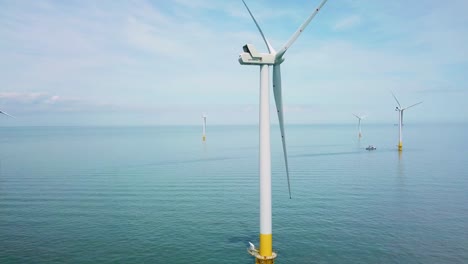 Remarkable-rising-drone-aerial-over-windmills-and-turbines-in-the-ocean-off-the-coast-of-England