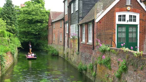 Boats-are-rowed-down-a-canal-in-Canterbury-Kent-England-1