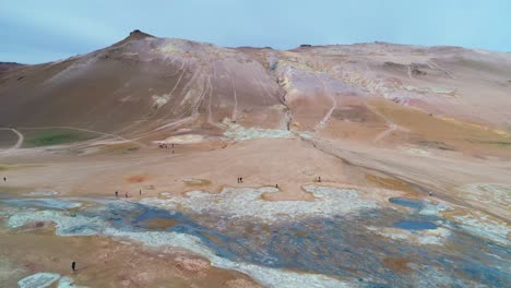 Dramatic-rising-aerial-over-Hverir-Myvatn-geothermal-area-in-iceland-reveals-the-lakes-distant-