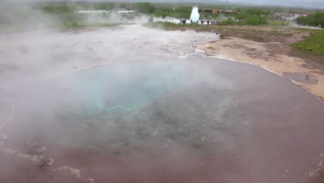 Iceland's-famous-Strokkur-geysir-geyser-erupts-with-the-Icelandic-countryside-in-background-1