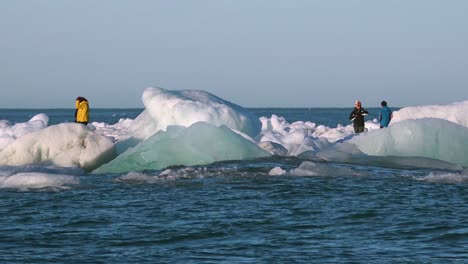 Los-Turistas-Caminan-Cerca-De-Los-Icebergs-A-La-Deriva-En-El-Ártico-Cerca-De-Jokulsarlon-Islandia