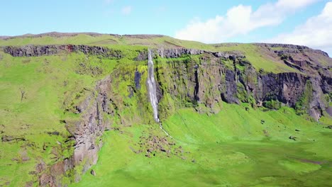 Aerial-of-a-generic-waterfall-in-Iceland-falling-over-steep-cliffs