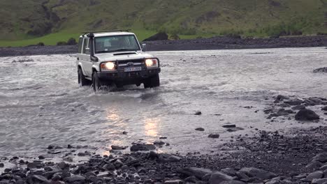 A-4WD-Toyota-Land-cruiser-drives-through-a-river-in-the-remopte-highlands-of-Iceland-near-Thorsmork
