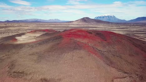 Spectacular-aerial-over-red-ash-topped-volcanoes-and-lava-flows-in-the-remote-highland-interior-of-Iceland-1