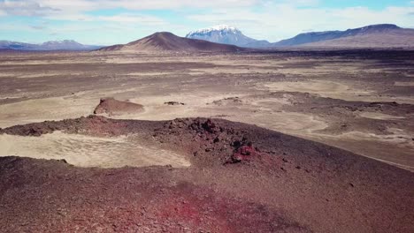 Spectacular-aerial-over-red-ash-topped-volcanoes-and-lava-flows-in-the-remote-highland-interior-of-Iceland-2