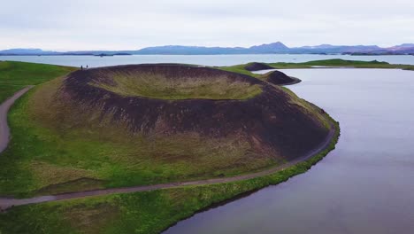 Beautiful-aerial-over-hikers-exploring-volcanic-cones-in-Lake-Myvatn-Iceland