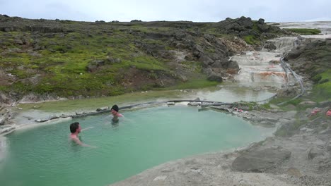 Tourists-bathe-in-the-Hveravellir-hot-springs-natural-geothermal-baths-in-the-highlands-of-central-Iceland