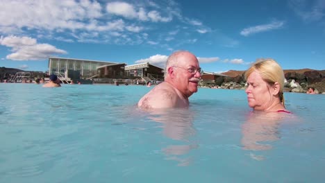 A-man-and-woman-swim-in-a-geothermal-pool-at-a-day-spa-in-Iceland