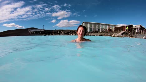 A-man-and-woman-swim-in-a-geothermal-pool-at-a-day-spa-in-Iceland-2