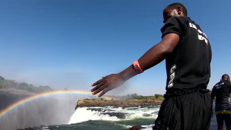 Ein-Mann-Taucht-In-Den-Teufelspool-Am-Rand-Von-Victoria-Falls-Sambia-Nahe-Dem-Rand-Der-Wasserfälle-1