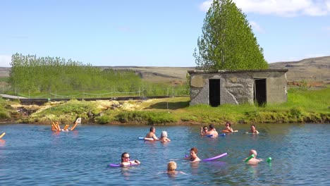 Tourists-and-Icelanders-enjoy-a-bath-in-a-hot-water-geothermal-spring-in-iceland-at-Fludir-Secret-Lagoon-3