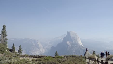 A-boy-on-a-rock-at-Glacier-Point-Yosemite-National-Park--Half-Dome-and-the-Sierra-Nevada-Mountains-in-the-distance-1