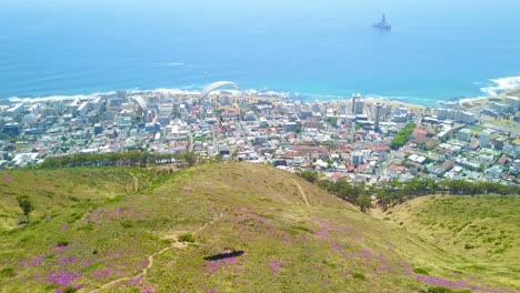 Drone-aerial-over-paragliding-and-paragliders-with-the-downtown-city-of-Cape-Town-South-Africa-in-background