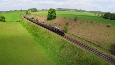 An-aerial-of-a-steam-train-as-it-passes-through-the-English-countryside-at-high-speed-1