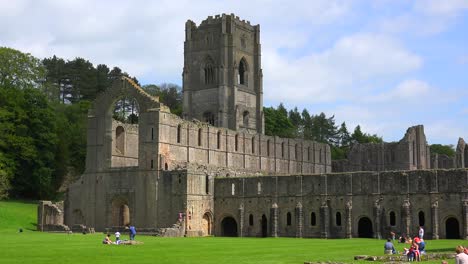An-abandoned-cathedral-abbey-of-Fountains-with-people-having-picnics-foreground-1