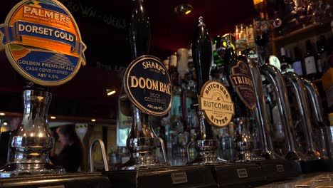 A-close-up-of-beer-taps-in-an-English-pub