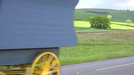 A-gypsy-caravan-passes-along-a-roadway-in-England
