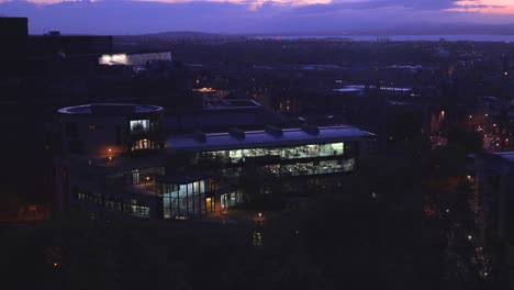 An-establishing-shot-of--a-modern-office-building-in-Edinburgh-Scotland-at-night