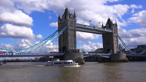 An-establishing-shot-of-the-Tower-Bridge-in-London-England-with-boat-passing-underneath