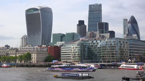 An-establishing-shot-of-the-Walkie-Talkie-and-other-business-buildings-along-the-River-Thames--in-downtown-London-England