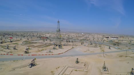 Amazing-aerial-shot-over-vast-oil-fields-and-derricks-near-Bakersfield-California-3