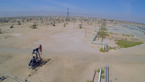 Amazing-aerial-shot-over-vast-oil-fields-and-derricks-near-Bakersfield-California-4