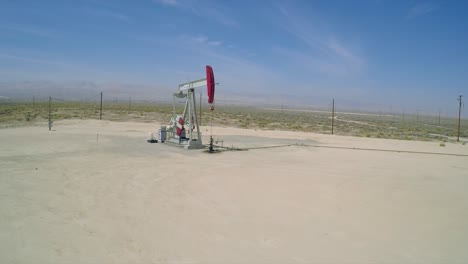 A-good-aerial-shot-over-an-oil-pumping-derrick-near-Bakersfield-California