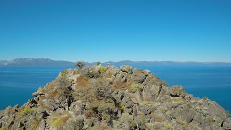 An-aerial-shot-over-a-hiker-on-a-mountaintop-in-Lake-Tahoe-Nevada-2