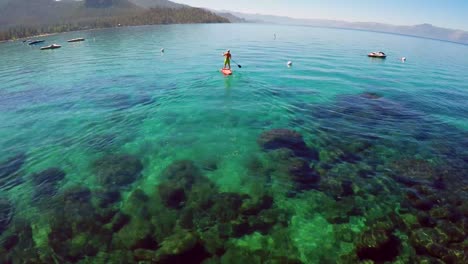 An-aerial-shot-over-a-paddle-boarder-rowing-on-Lake-Tahoe-1