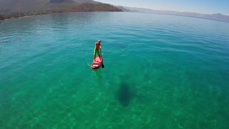 An-aerial-shot-over-a-paddle-boarder-rowing-on-Lake-Tahoe-2