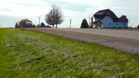 A-pickup-truck-passes-on-a-rural-farm-road-in-the-Midwest