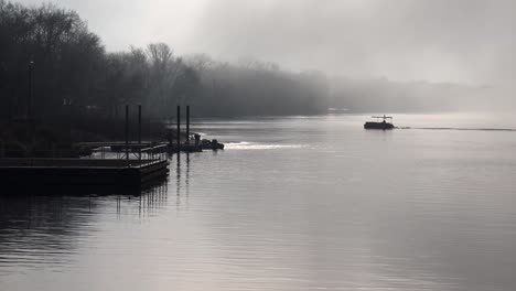Fishing-boats-head-out-on-a-foggy-morning-along-the-Mississippi-River
