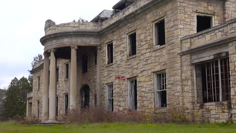 Facade-of-an-abandoned-and-spooky-old-boarding-school-or-mansion-in-the-countryside