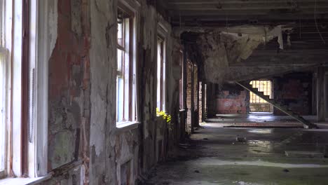 Pan-across-an-abandoned-and-spooky-interior-of-old-building