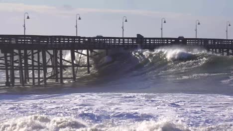 Huge-waves-crash-on-a-California-beach-and-pier-during-a-very-large-storm-event-1