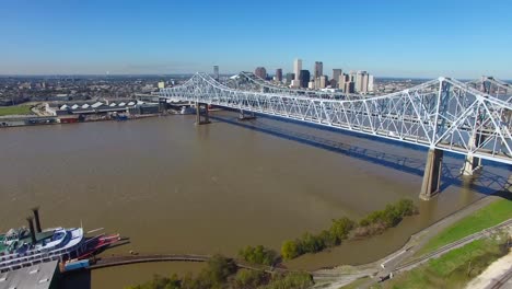 Aerial-shot-of-the-Crescent-City-Bridge-over-the-Mississippi-River-revealing-the-New-Orleans-Louisiana-skyline