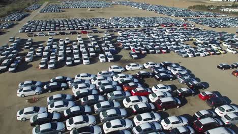 Aerial-perspective-of-new-import-cars-sitting-in-a-lot-awaiting-distribution-and-sale