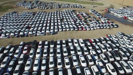 Aerial-perspective-of-new-import-cars-sitting-in-a-lot-awaiting-distribution-and-sale-1