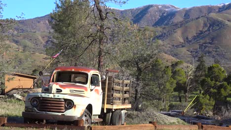 An-old-abandoned-pickup-truck-sits-beside-a-mountain-road