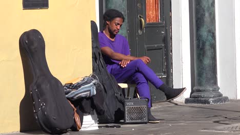 A-homeless-musician-sits-on-the-street