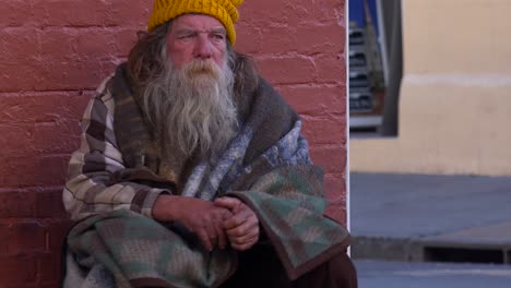 A-homeless-man-sits-on-the-street-1