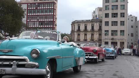 Classic-old-cars-are-driven-through-the-colorful-streets-of-Havana-Cuba-8