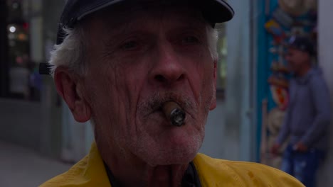 An-old-man-smokes-a-cigar-on-the-street-in-Havana-Cuba
