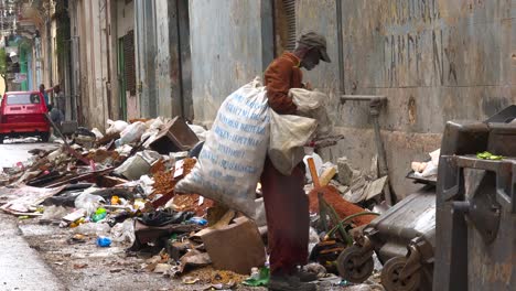 A-man-collects-garbage-along-the-streets-of-Havana-Cuba